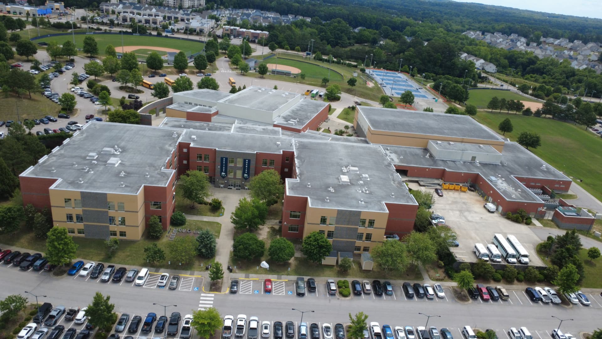 Aerial view of Heritage High School campus with athletic fields and tennis courts
