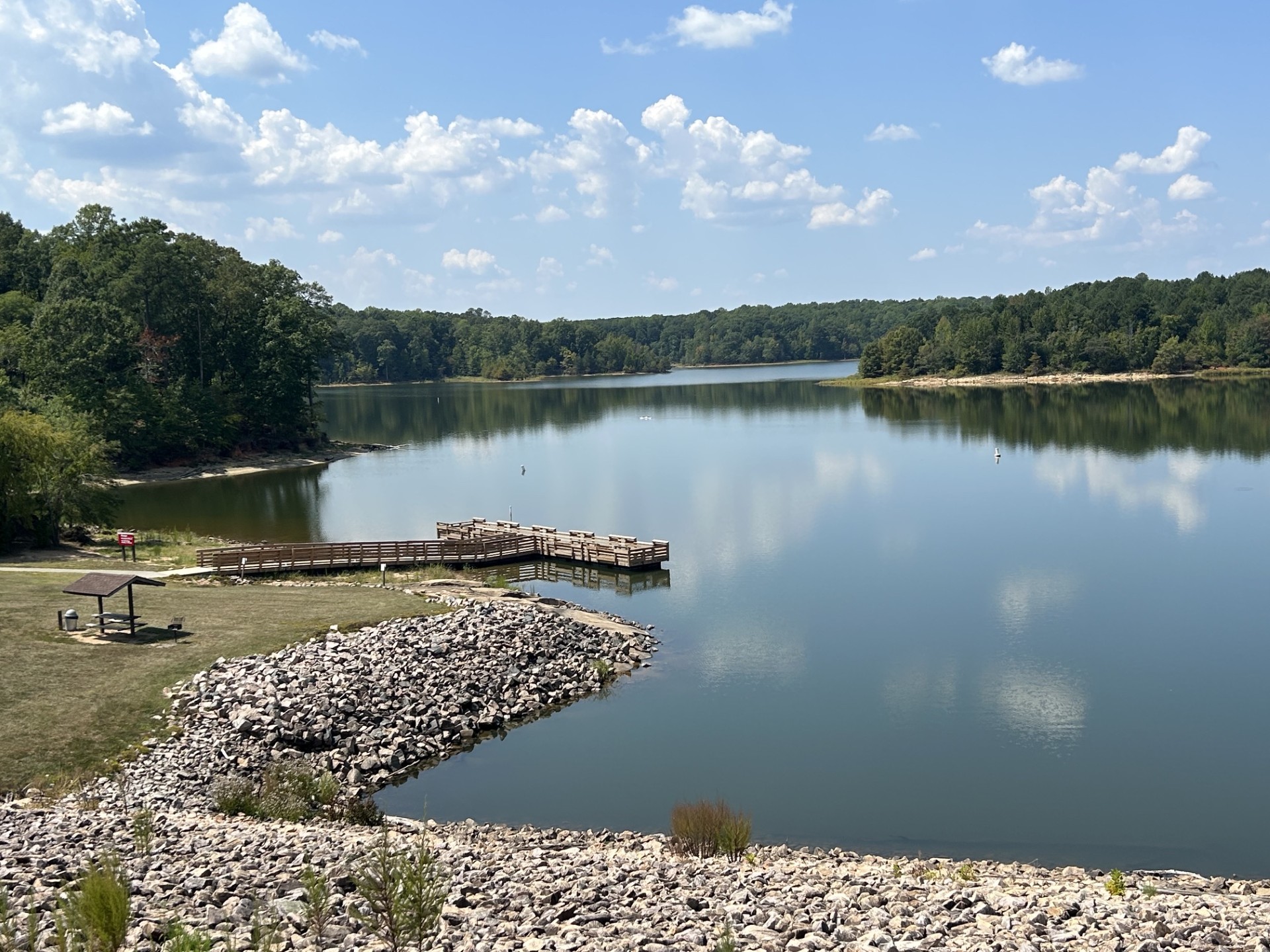 Falls Lake shoreline with a wooden pier and picnic pavilion near Wake Forest